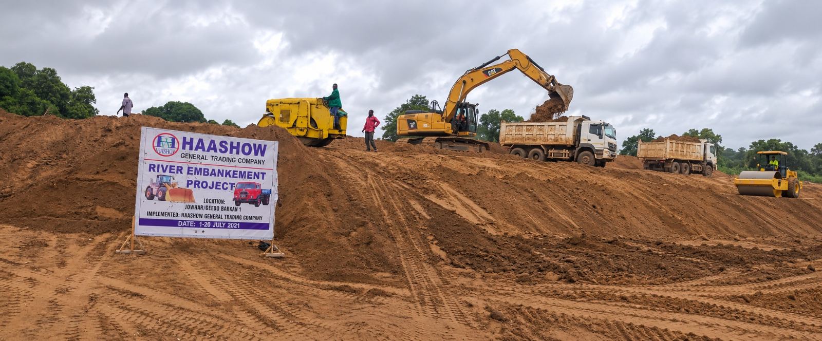 AI-edited Haashow Jowhar embankment project photograph with additional excavator and tipper trucks